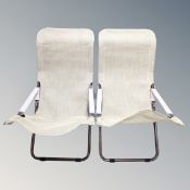 A pair of folding adjustable garden armchairs