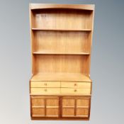A mid century Nathan teak open bookcase fitted a drawer and cupboard beneath