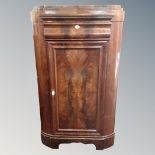 A 19th century mahogany corner cabinet fitted a drawer