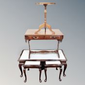 A nest of three mahogany glass topped tables together with further sofa table and wine table