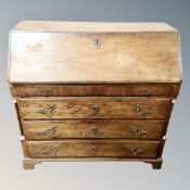A 19th century oak bureau fitted with four drawers