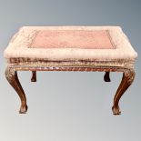 A mahogany and beech dressing table stool on claw and ball feet