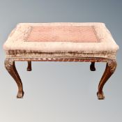 A mahogany and beech dressing table stool on claw and ball feet