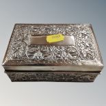 A middle Eastern embossed silver cigarette box