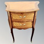 A French Kingwood two drawer chest on raised legs with ormolu mounts