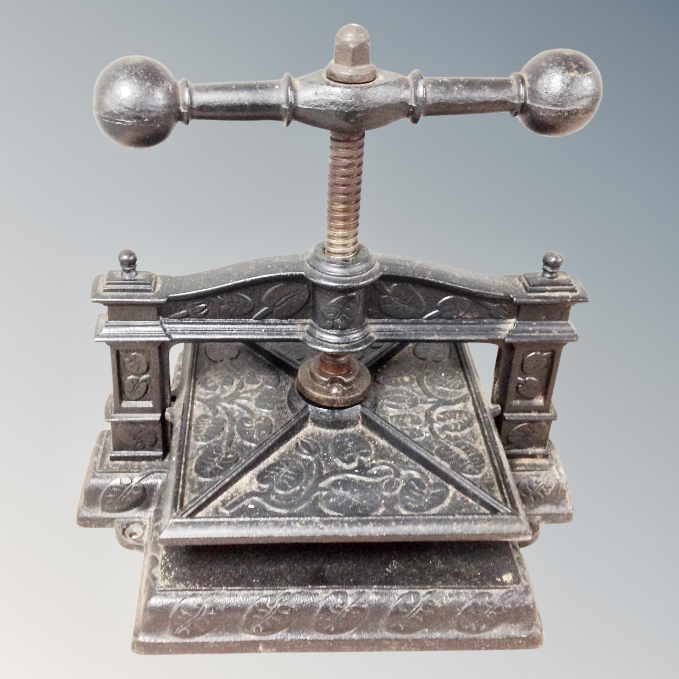 A 19th century cast iron book press embossed with leaves