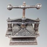 A 19th century cast iron book press embossed with leaves