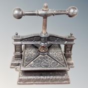 A 19th century cast iron book press embossed with leaves