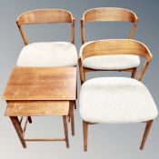 A set of three mid century teak dining chairs together with a further nest of two tables