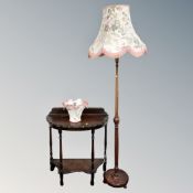 An Edwardian oak demi lune two-tier hall table together with beechwood standard lamp,