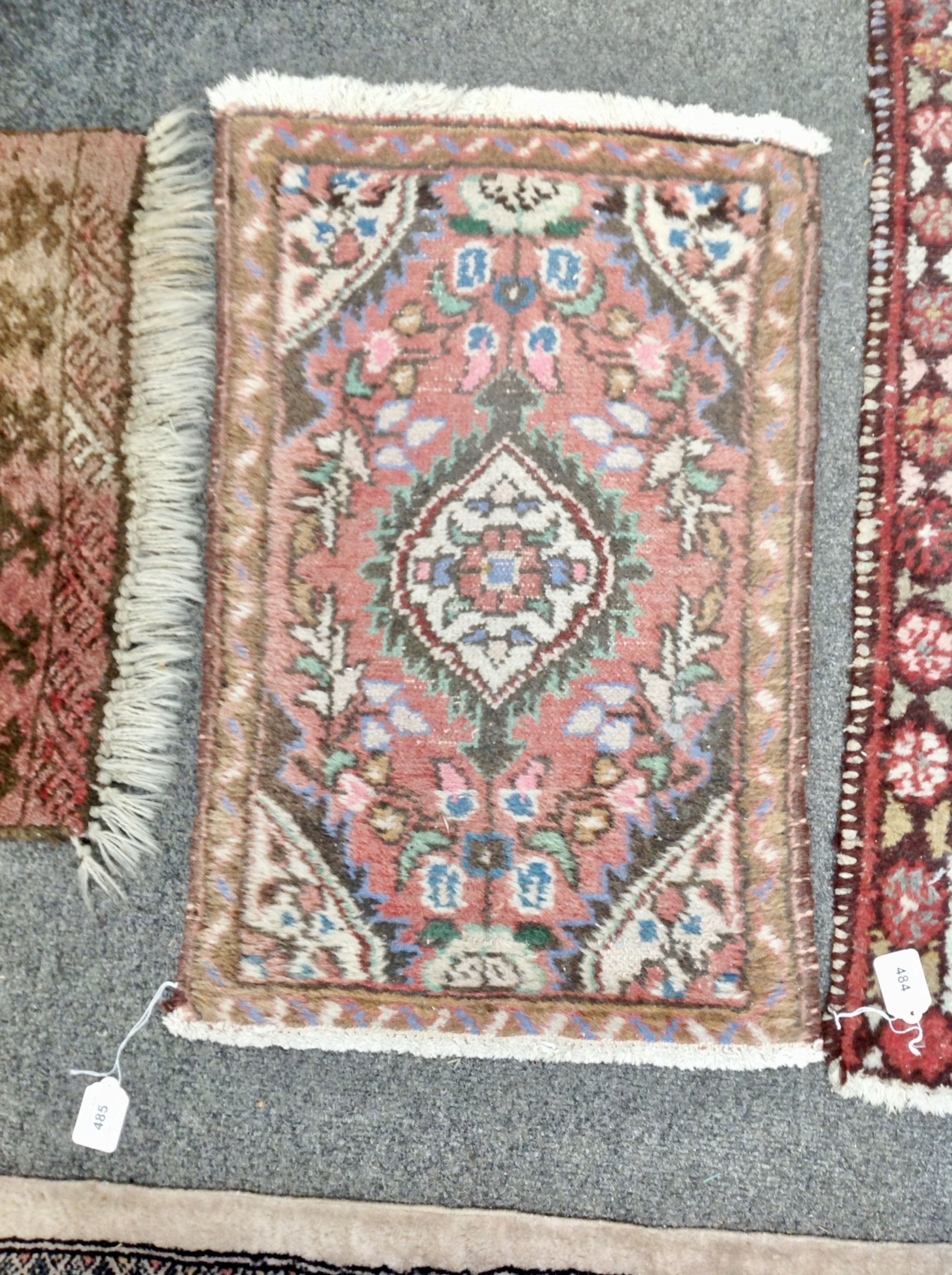 An Eastern hearth rug 68 cm x 42 cm