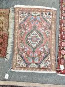 An Eastern hearth rug 68 cm x 42 cm