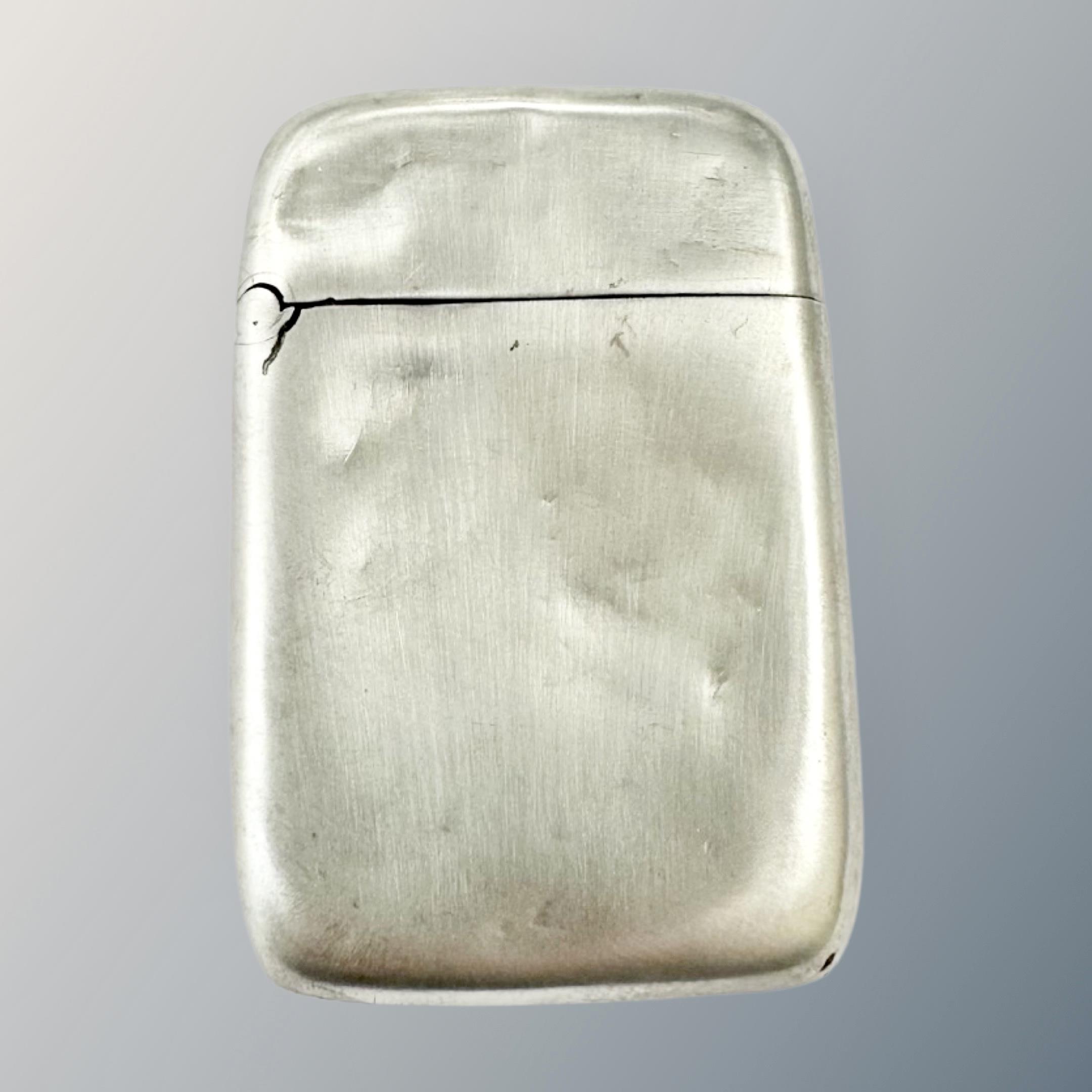 A silver vesta case