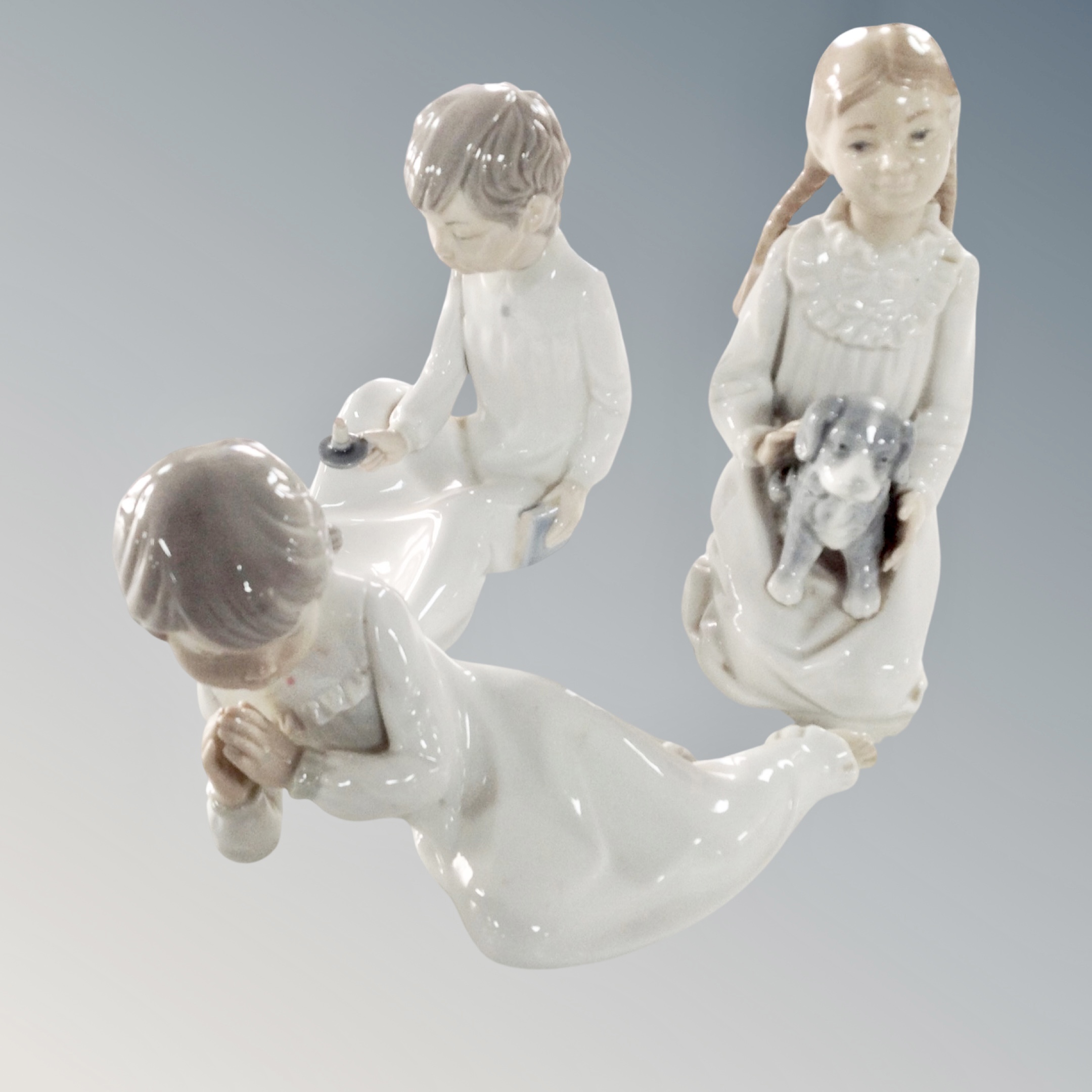 Three Nao figures : children in night dress