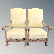 A pair of early 20th century carved oak scroll arm throne chairs in golden fabric