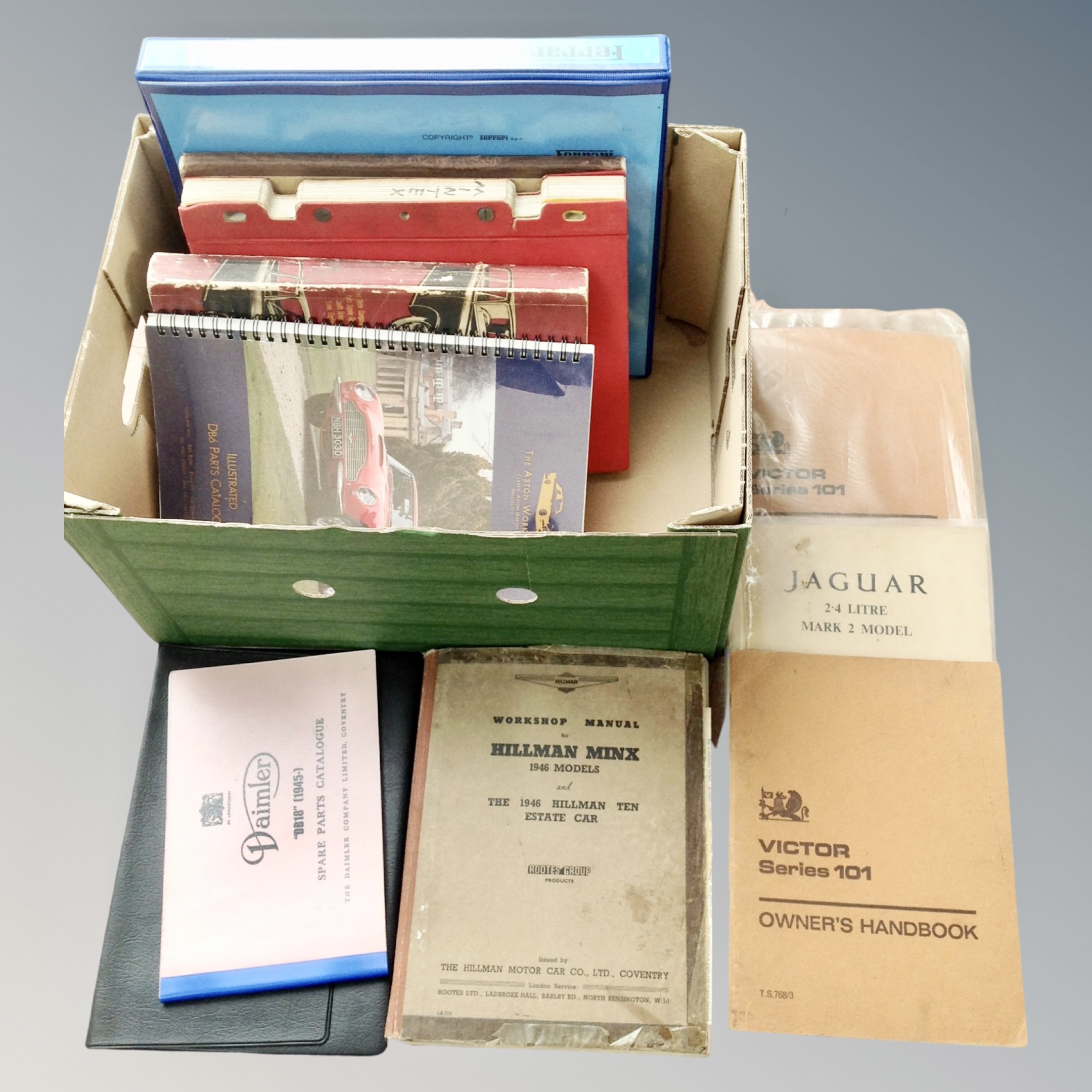 A box of mid 20th century and later car owner's hand books and parts lists to include Ferrari,