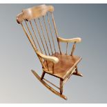 A beechwood spindle backed rocking chair