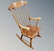 A beechwood spindle backed rocking chair