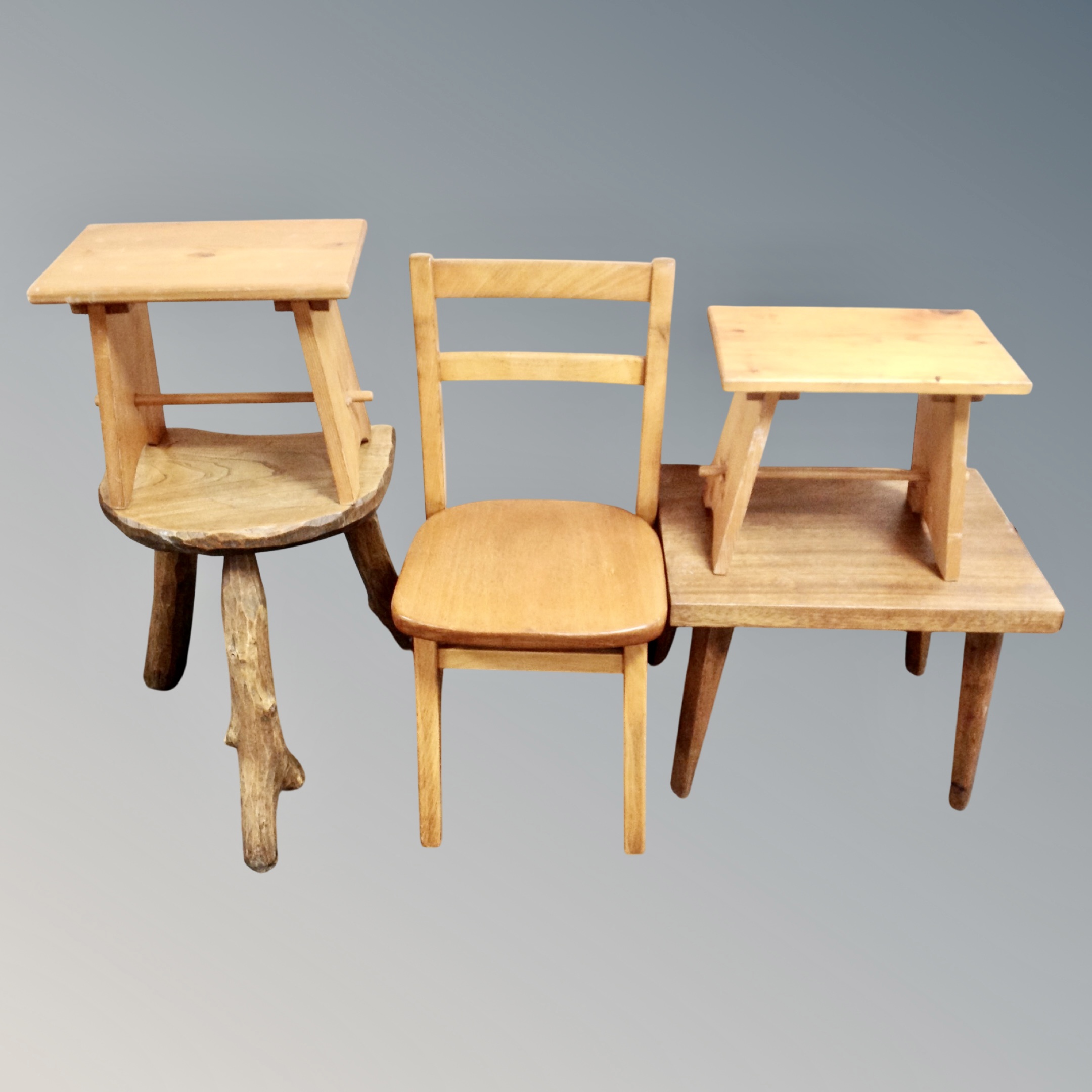 A rustic milking stool together with a pair of pine crackets,