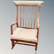 A mid century beech spindle backed rocking chair