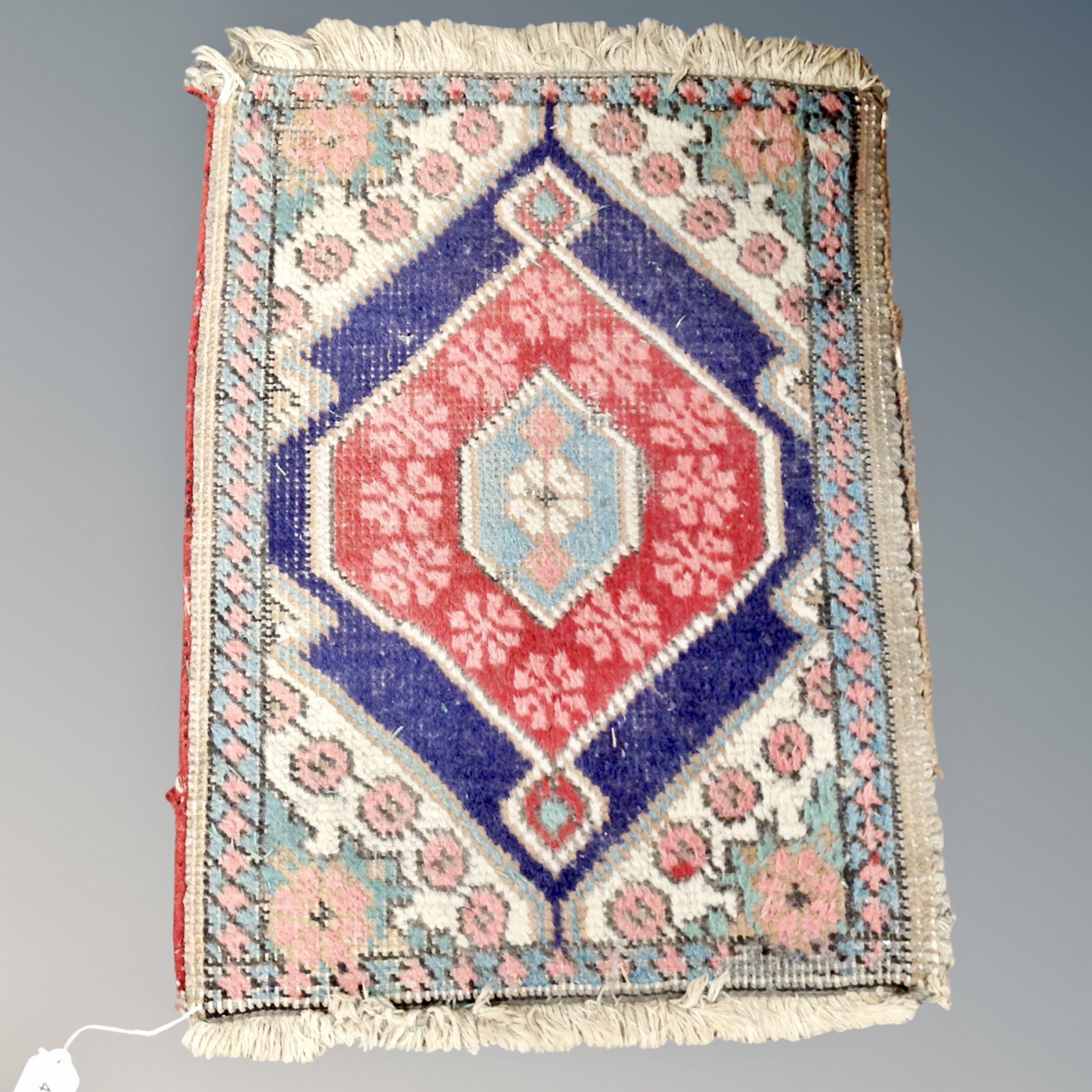 A small Eastern hearth rug 57 cm x 42 cm