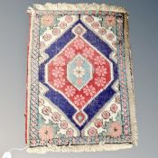 A small Eastern hearth rug 57 cm x 42 cm