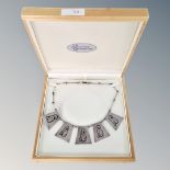 A silver necklace with five panels of Aztec style decoration, weight 26.5g, in box.
