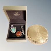 A silver brooch, a further brooch and pendant with inset stone,