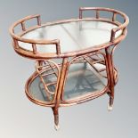 A bamboo and glass two-tier drinks trolley,