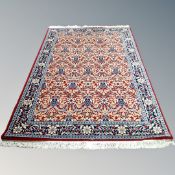 A machine made Keshan design rug on red ground 150 cm x 230 cm