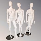 Three female full body mannequins on stands