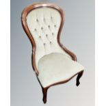 A Victorian style nursing chair in green buttoned fabric