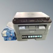 A Brother DCP -L2500D printer together with two boxed cartridges