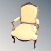 A carved walnut framed Louis XV style chair in yellow fabric