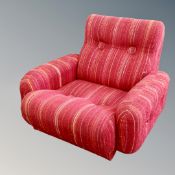 A 1970's low armchair in red striped fabric