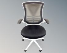 An office armchair upholstered in a black mesh fabric (white)