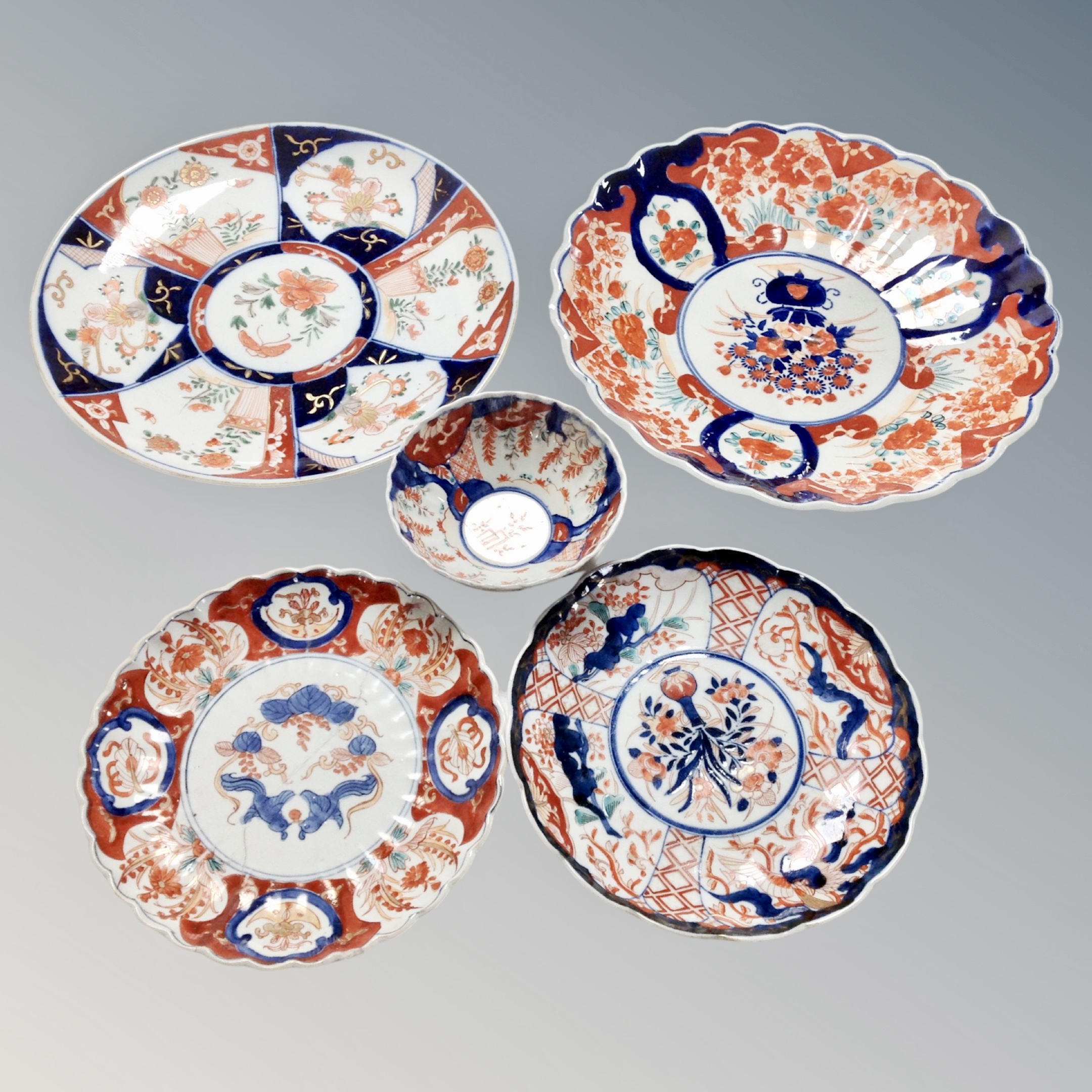 A tray of five Imari scalloped edged plates,