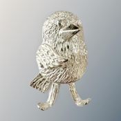 A silver bird charm