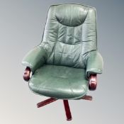 A Danish green leather swivel relaxer chair
