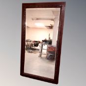 A large bevelled mirror in an antique frame