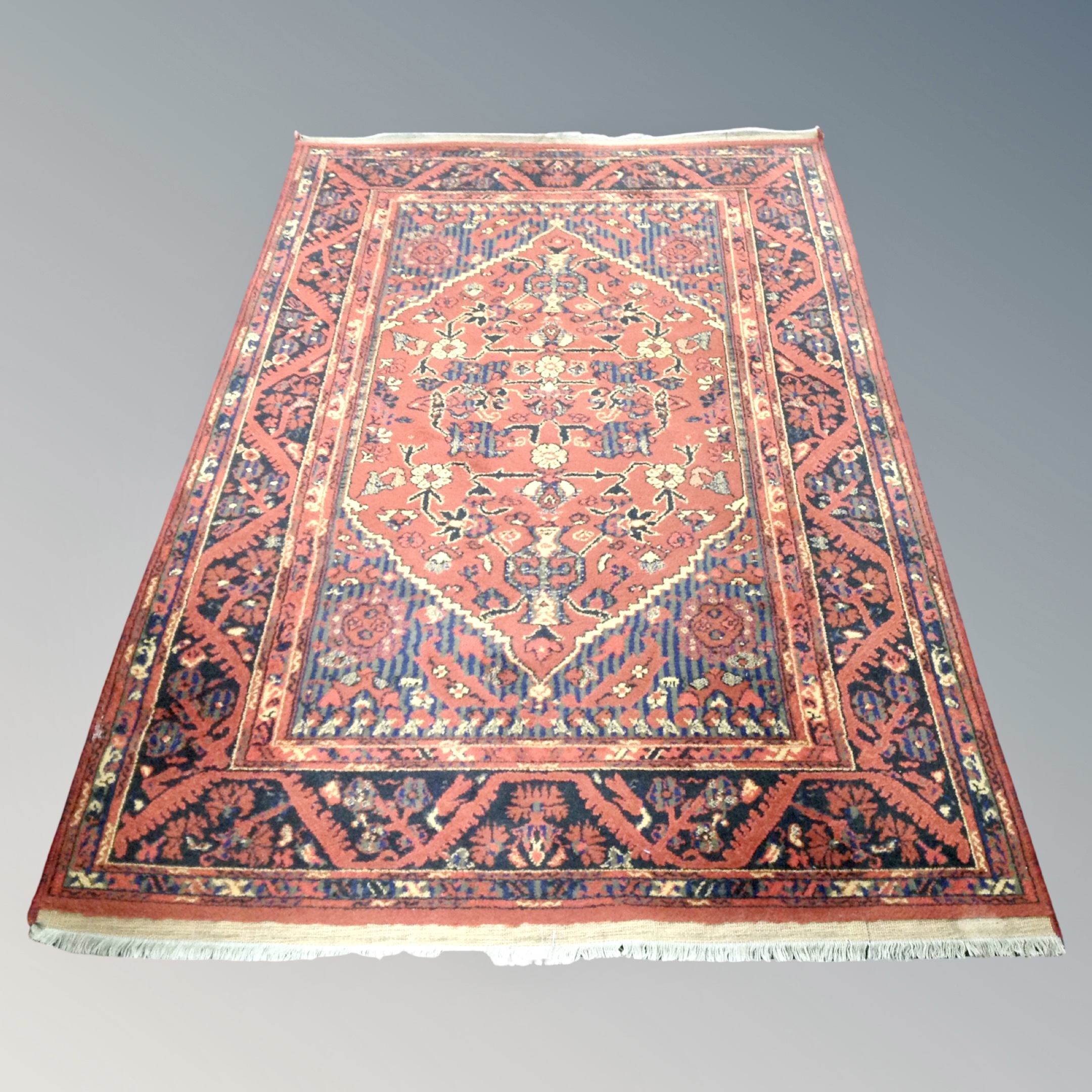 A Hamadan rug on rust ground 130 cm x 200 cm