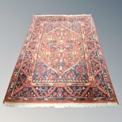 A Hamadan rug on rust ground 130 cm x 200 cm
