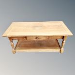 An oak two -tier coffee table fitted a drawer, height 45 cm, width 105 cm, depth 55 cm.