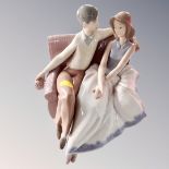 A Nao figure - couple seated on sofa