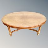 A contemporary oval coffee table in mahogany gloss finish