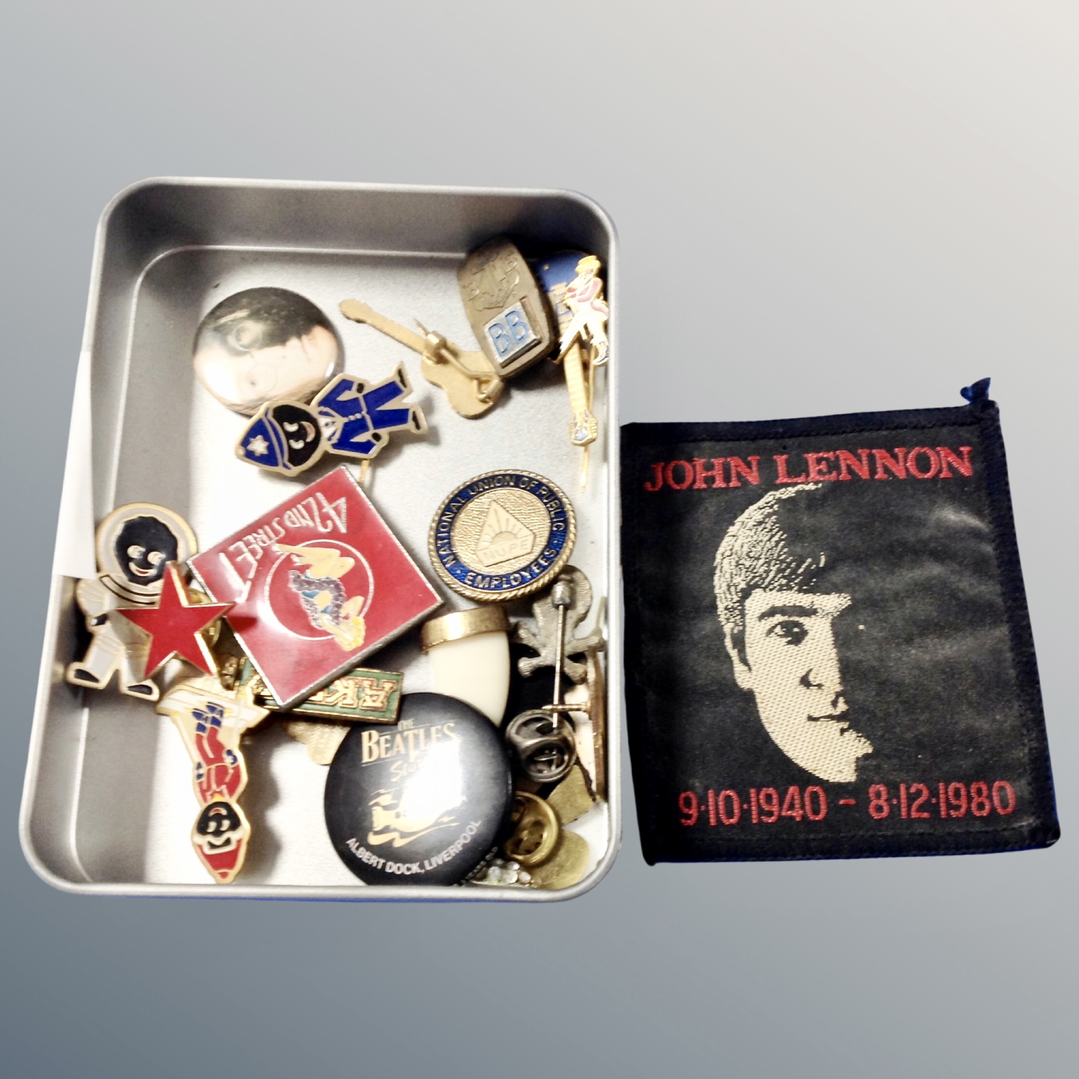 A tin of Beatles pin badges, sew on badge,