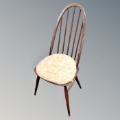 An Ercol elm and beech spindle backed dining chair in antique finish