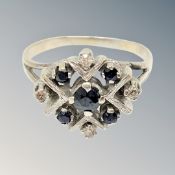 A white gold sapphire and diamond cluster ring,