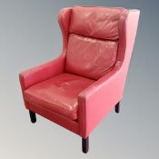 A 20th century Danish red leather wing backed armchair