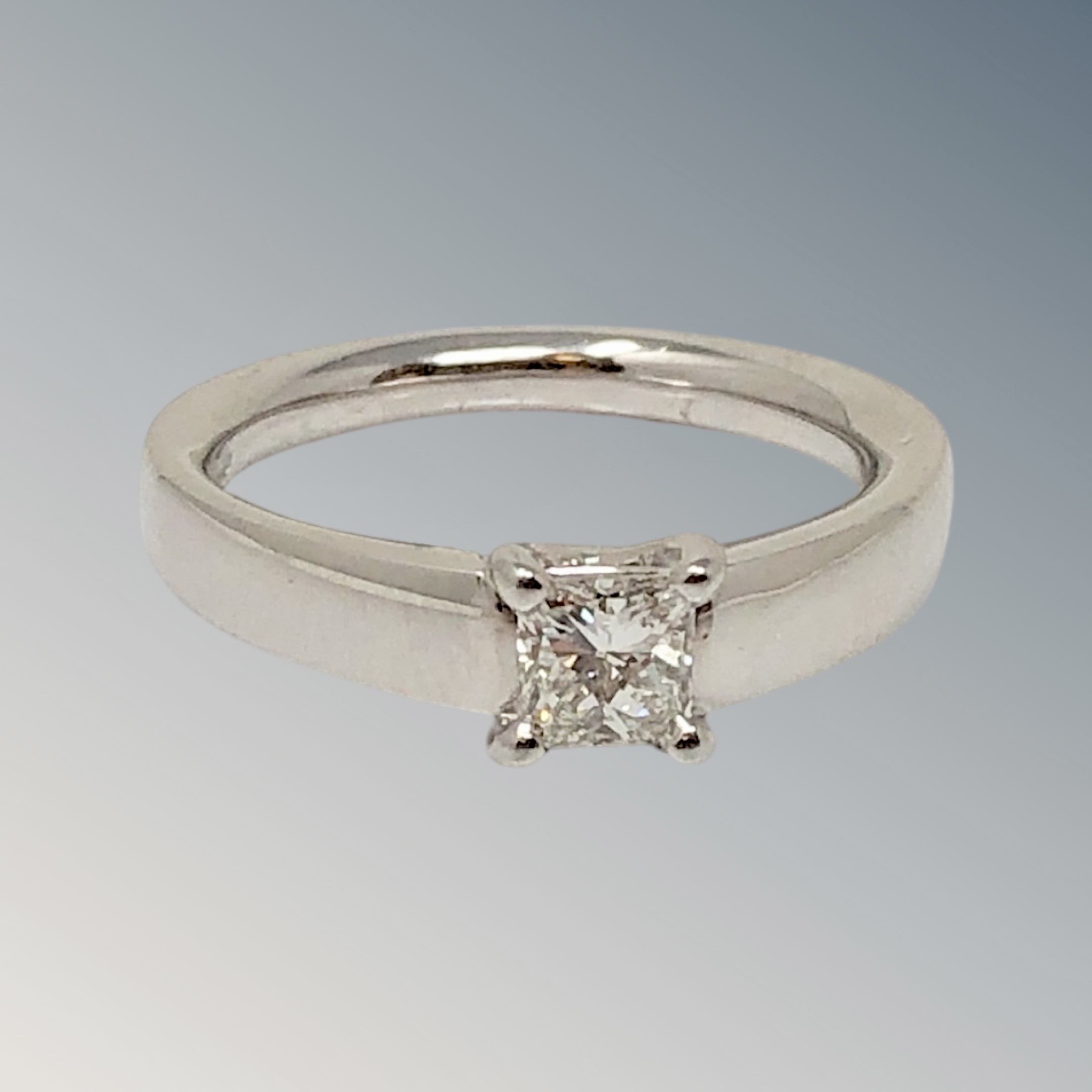 An 18ct white gold princess cut solitaire diamond ring, approximately 0.